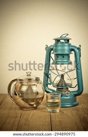 still life,old lamp and tea on wooden table,vintage picture
