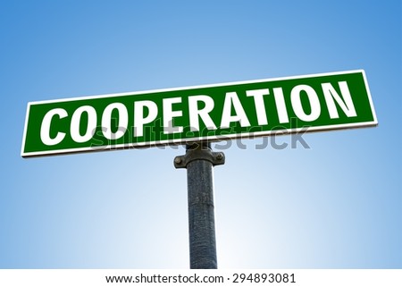 COOPERATION word on green road sign