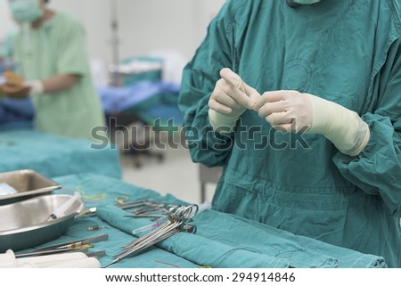 scrub nurse preparing medical instruments for operation