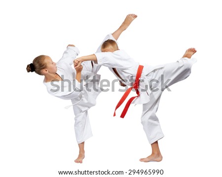 Mavashi geri and gyaku-tsuki beats sportsmens in karategi Royalty-Free Stock Photo #294965990