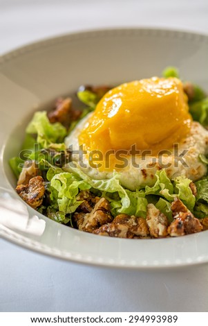 cheese and mango ice-cream salad with nuts and lettuce