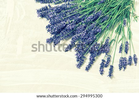 Lavender flowers over rustic wooden background. Fresh blossoms. Vintage style toned picture