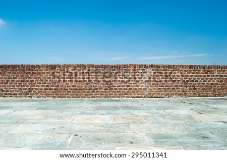 brick wall with blue sky background Royalty-Free Stock Photo #295011341