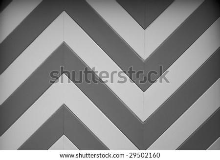 a black and white chevron or zig zag wood design of a garage door on an older home