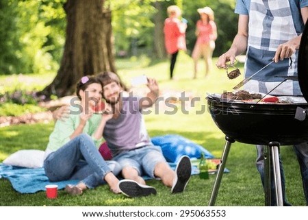 Happy people doing grill in the park