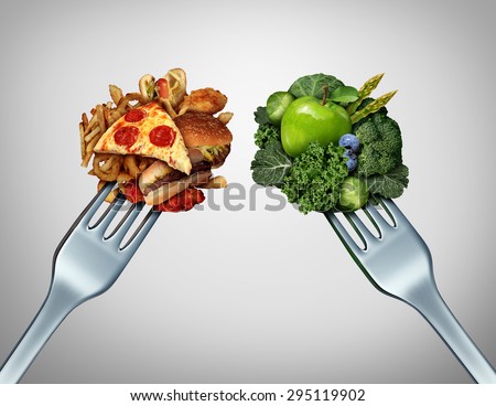Diet struggle and decision concept and nutrition choices dilemma between healthy good fresh fruit and vegetables or cholesterol rich fast food with two dinner forks competing to decide what to eat.  Royalty-Free Stock Photo #295119902