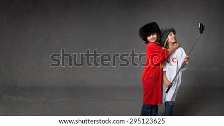 russian children taking selfie, dark background