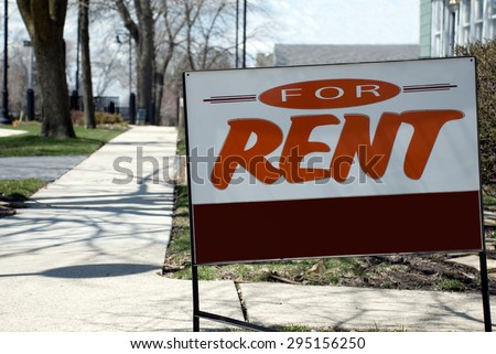 For Rent Sign. Picture of a for rent sign in front of a house in a suburban neighborhood
