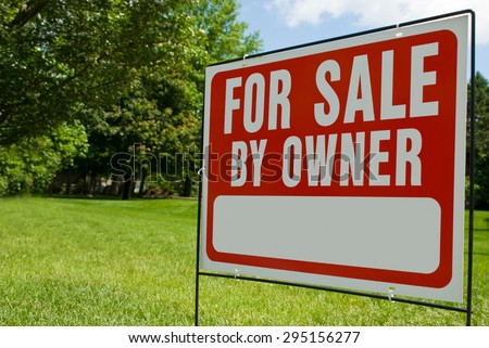 For Sale By Owner Sign. Picture of a For Sale By Owner sign in a yard. Has copy space for adding text.