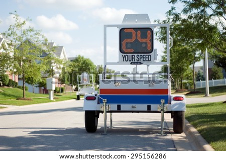 Police Mobile Radar Speed Trailer. Picture of a mobile police radar trailer with an LED sign displaying speed.
