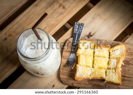 top view of milk with sweet toast on wooden table