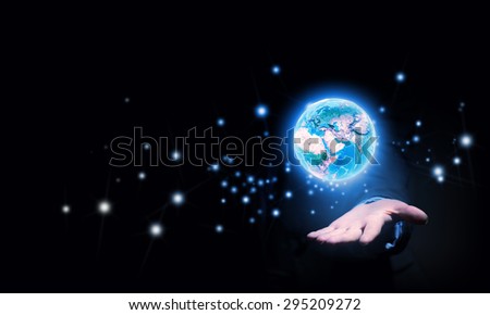 Human hand holding digital icon of planet earth. Elements of this image are furnished by NASA