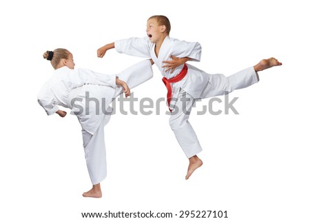 Gyaku-tsuki and mavashi geri are beating sportsmens in karategi Royalty-Free Stock Photo #295227101