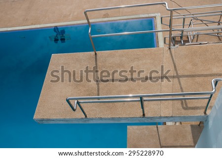View on the top of diving platform at a swimming pool  Royalty-Free Stock Photo #295228970