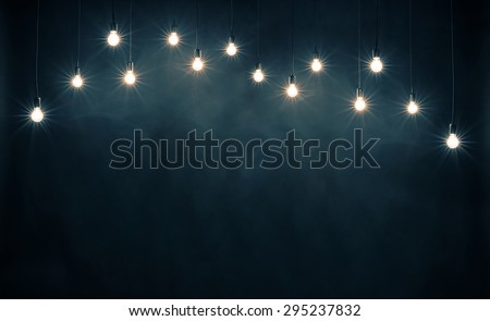 Light bulbs on dark blue background Royalty-Free Stock Photo #295237832