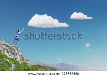 Happy young woman dreaming to fly in sky