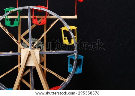 Old and dirty ferris wheel toy model represent the toy and amusement background concept related idea.