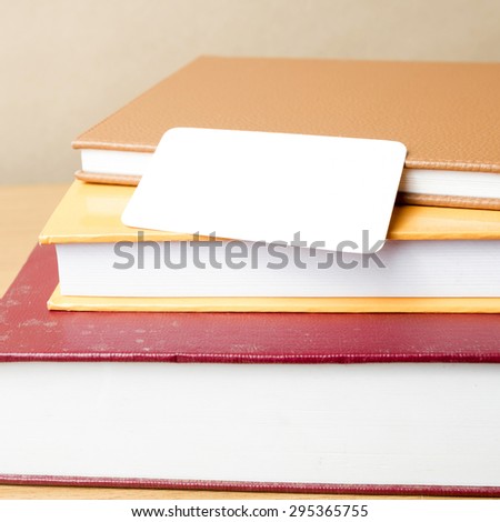stack of book and business card on wood background