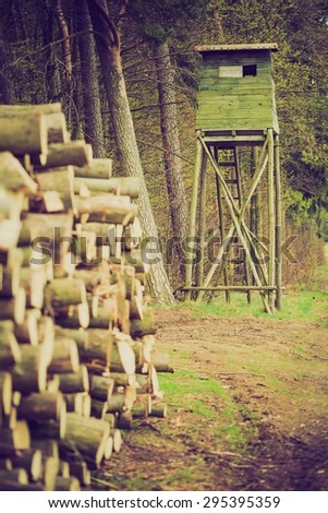 Landscape of field with raised hide and forest. photo with vintage mood effect 