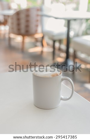 white coffee cup in coffee shop - vintage style effect picture