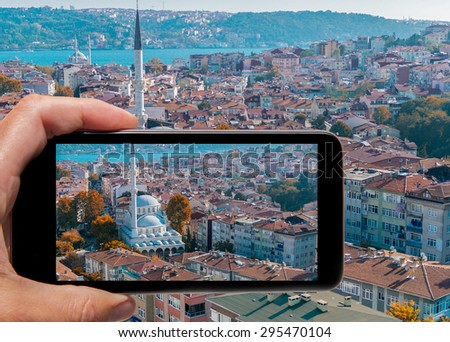 Male hand with smartphone taking a picture of Istanbul. Tourism concept.
