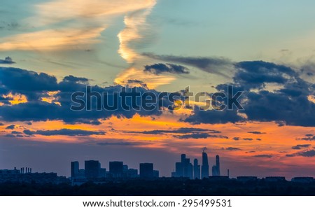 Beautiful orange sunset over the city with different clouds