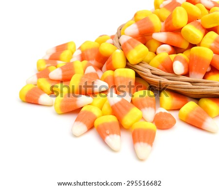 Candy corn in basket on white background 
