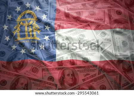 colorful waving georgia state flag on a american dollar money background