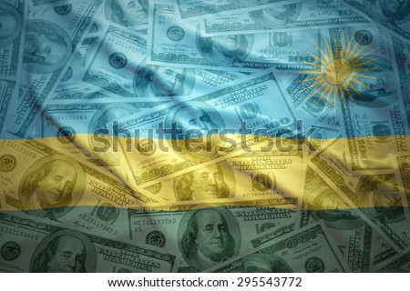 colorful waving rwandan flag on a american dollar money background