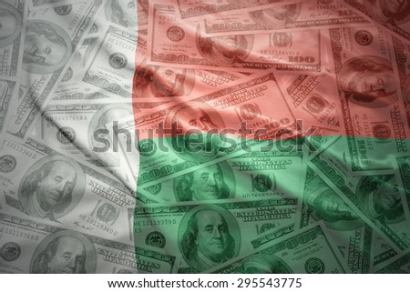 colorful waving madagascar flag on a american dollar money background