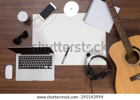 Office desk background, Acoustic guitar and headphones recording scene project ideas concept, With laptop computer, mobile phones, drawing equipment and cup of coffee. View from above with copy space