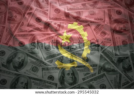 colorful waving angolan flag on a american dollar money background