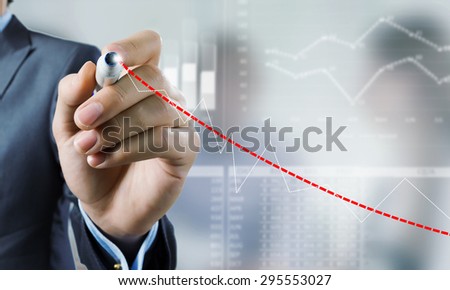 Close up of businessman drawing increasing graph with marker on media screen