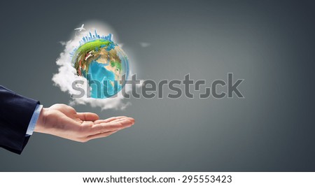 Close up of male hand holding our Earth planet. Elements of this image are furnished by NASA