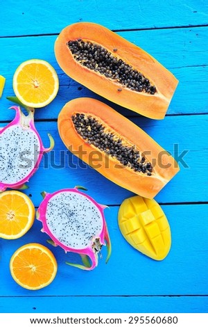 Tropical fruits slice on blue paint wooden floor.