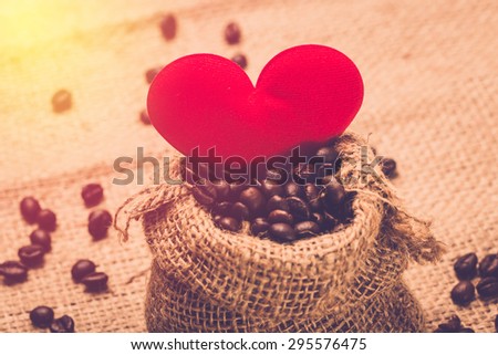 Coffee lover concept. Red heart and coffee bean. Vintage filter.