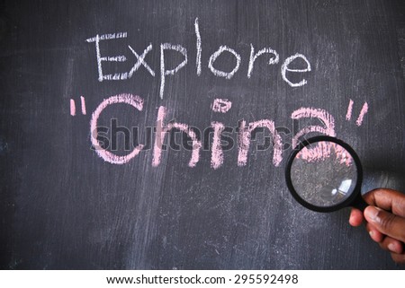 Explore word written on blackboard with chalk. Concept is to discover a new country. This photo may use as travel and living background.