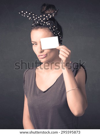 Pretty girl holding blank copy space paper at her eyes concept