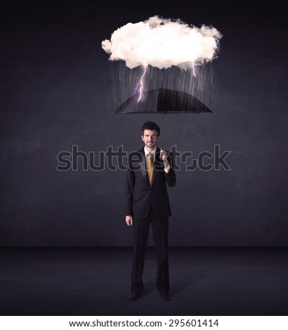 Businessman standing with umbrella and little storm cloud concept on background