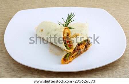 Wrap tortilla with meat, vegetables and spices