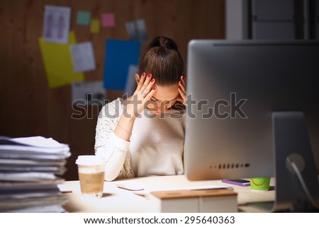 Young and beautiful businesswoman tired from work in the office Royalty-Free Stock Photo #295640363