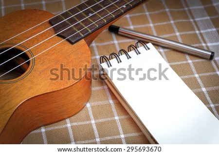 ukulele and note on brown cavas