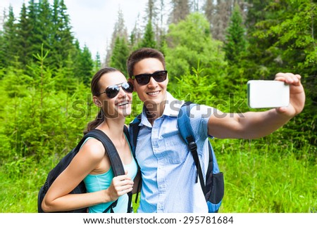 Couple taking a photo in nature.
