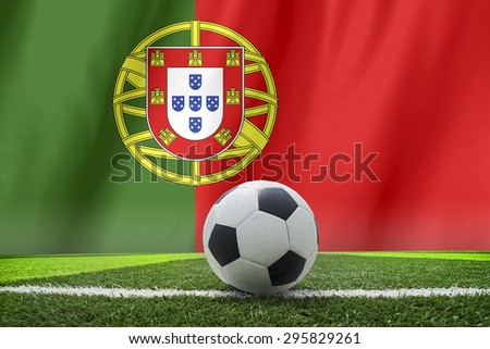 soccer ball in front of the Portugal flag 