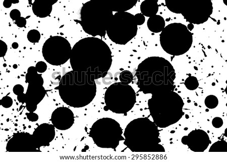 Drops of black ink on a white background.