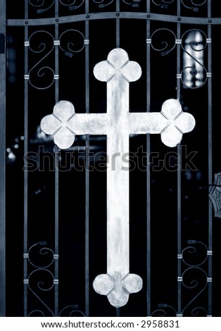 Old metal church doors with big iron cross