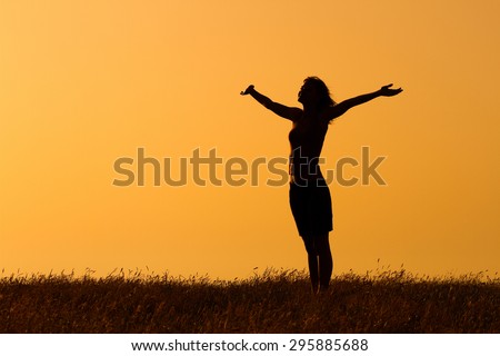 Happy woman enjoys in sunset. Greeting the sunset Royalty-Free Stock Photo #295885688