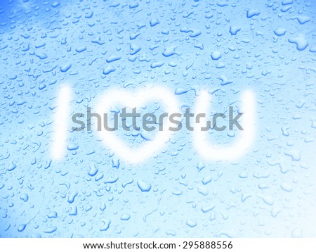 "I LOVE YOU" message on blue background of water drops