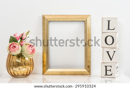 Mock up with golden frame and flowers. Vintage style interior with space for your picture or text. Love concept