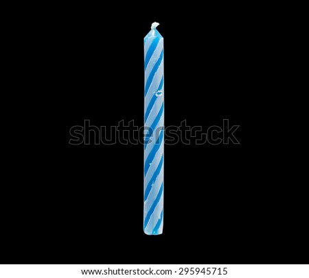 blue birthday candle on black background